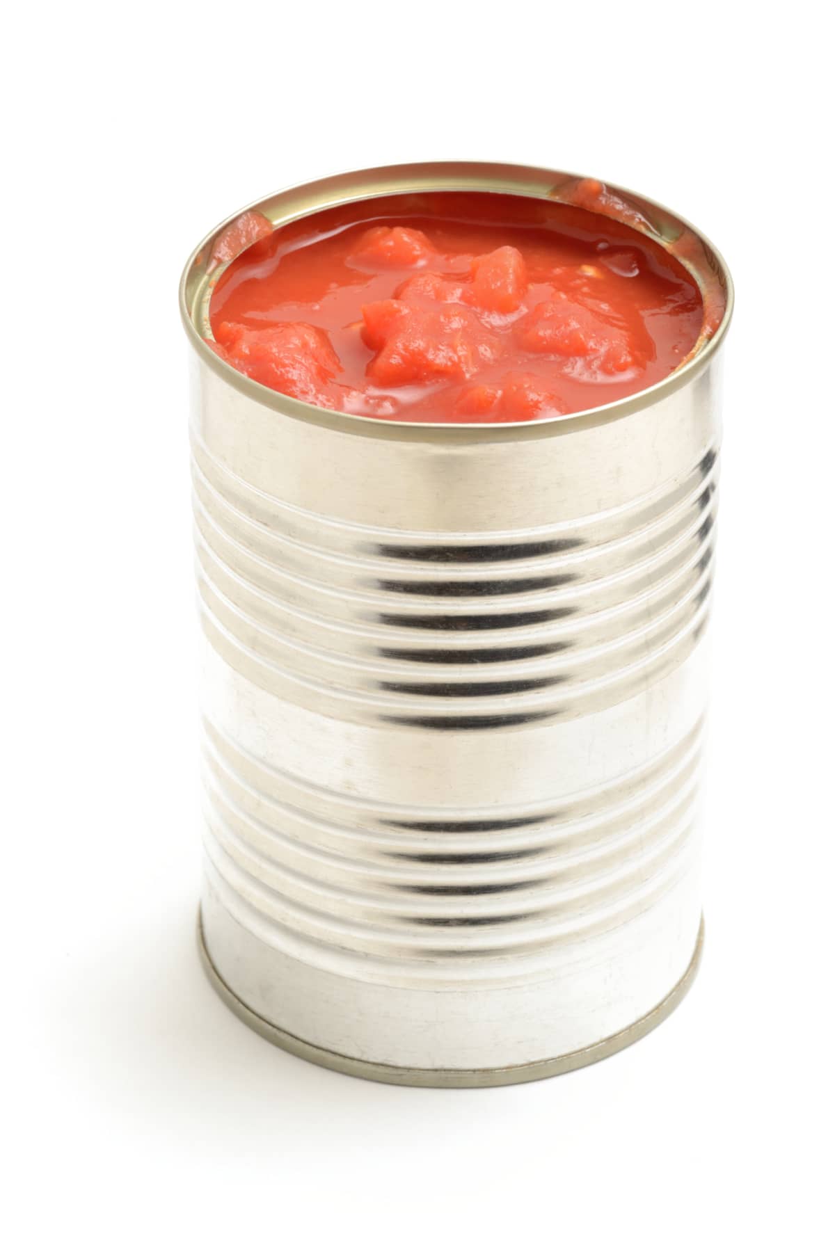 Chopped tomatoes in an opened tin, isolated on a white background.