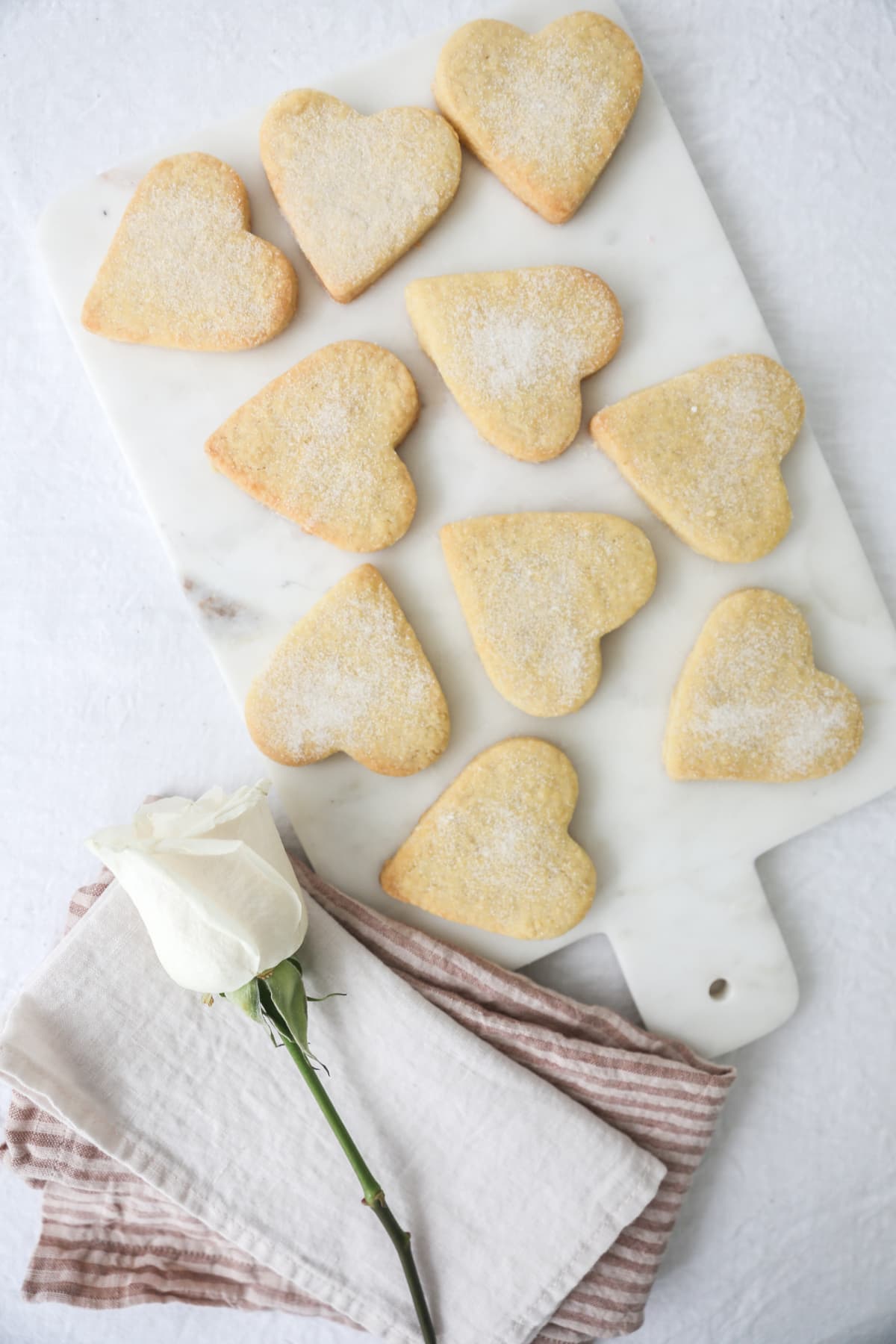 Delicate homemade shortbread fingers in vertical format shot in natural light with copy space
