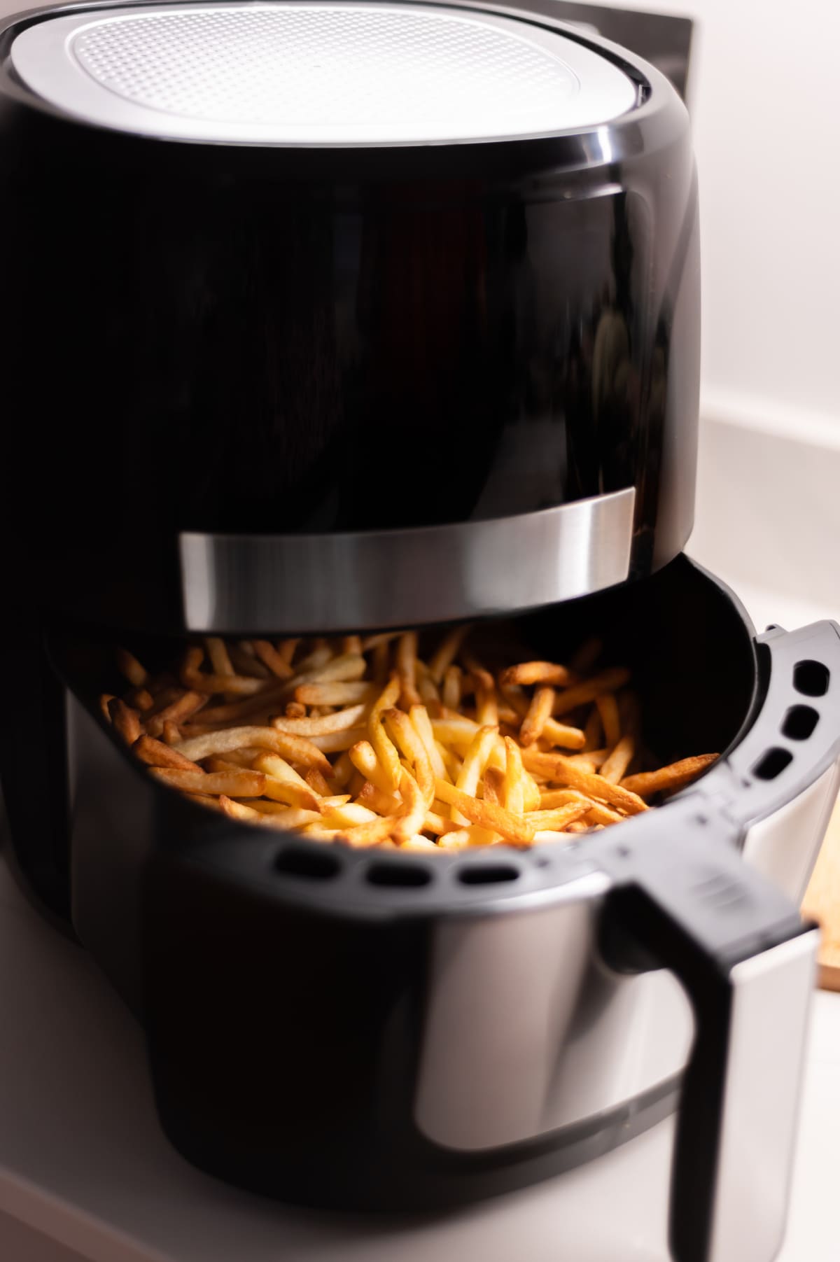 Chips or french fries made in tendy kitchen gadget air fryer, small countertop convection oven, deep fast frying oil free, more healthful way to cook deep-fried food