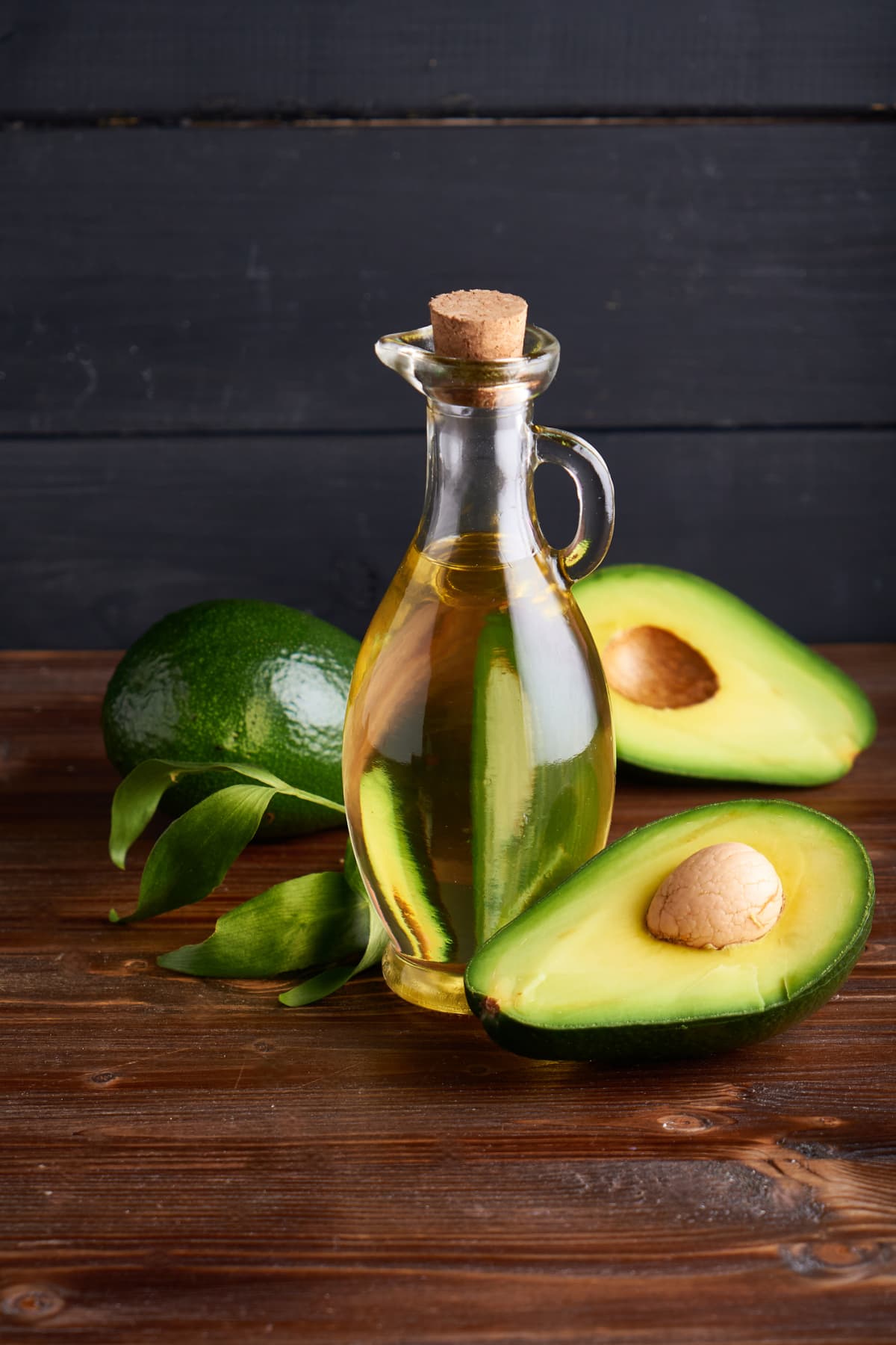 Bottle of avocado oil on white background