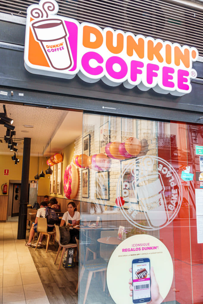 Spain, Valencia, Calle de la Paz, Dunkin' Coffee shop, sign promoting on-line app. (Photo by: Jeff Greenberg/Education Images/Universal Images Group via Getty Images)