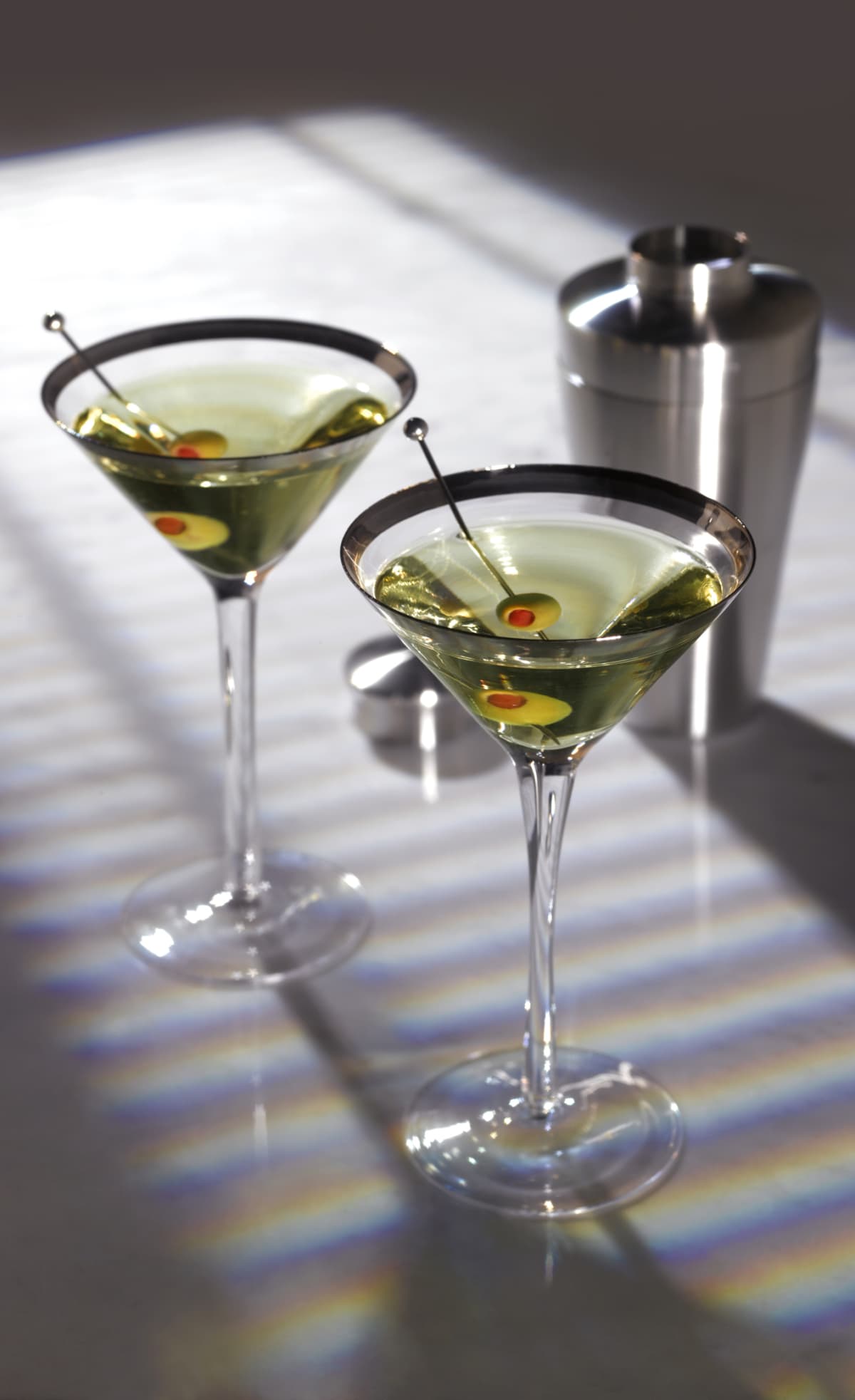 Two martinis with olive garnish