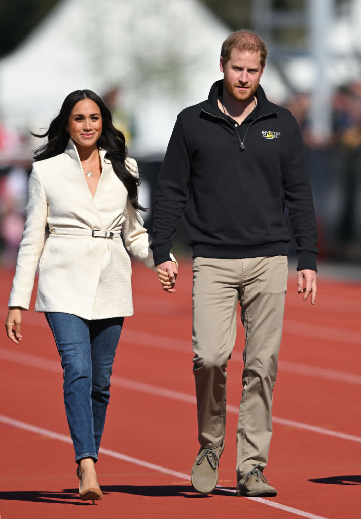 THE HAGUE, NETHERLANDS - APRIL 17: Prince Harry, Duke of Sussex and Meghan, Duchess of Sussex attend the athletics event during the Invictus Games at Zuiderpark on April 17, 2022 in The Hague, Netherlands. (Photo by Karwai Tang/WireImage)