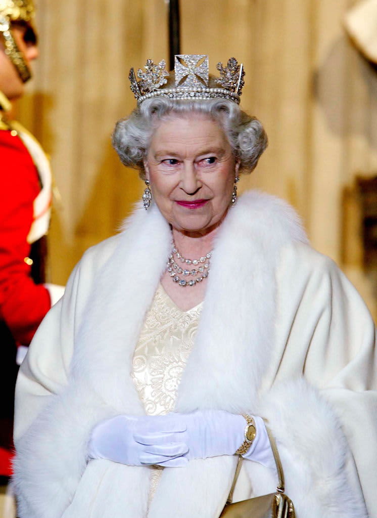 LONDON, UNITED KINGDOM - NOVEMBER 13:  Queen Elizabeth II Smiling As She Arrives At The Palace Of Westminster For The State Opening Of Parliament.  The Queen Is Wearing A Diamond Crown Known As The State Diadem Made For The Coronation Of George Lv.  She Is Wearing An Embroidered Cream Satin Dress Covered With A Fur-trimmed Robe.  (Photo by Tim Graham Picture Library/Getty Images)