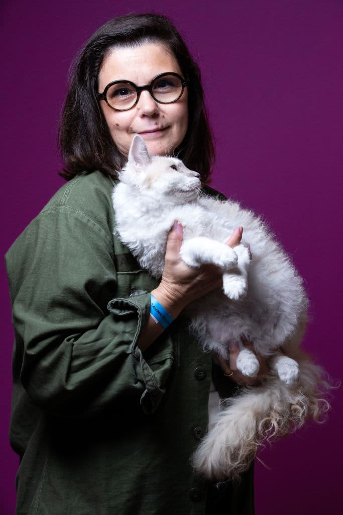 Maria Fournier poses with Mina a cat of the Laperm breed on October 1, 2021 ahead of the Animal Expo Fair which takes place on October 2 and 3 at the Parc Floral, in Paris. (Photo by JOEL SAGET / AFP) (Photo by JOEL SAGET/AFP via Getty Images)