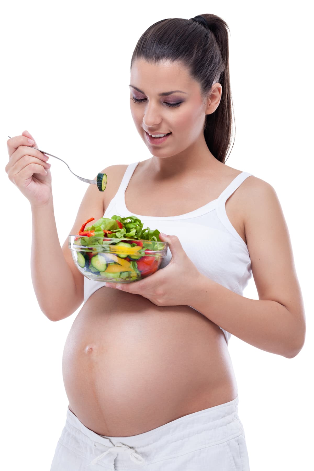 young pregnant woman eating healthy vegetable salad, healthy nutrition and pregnancy