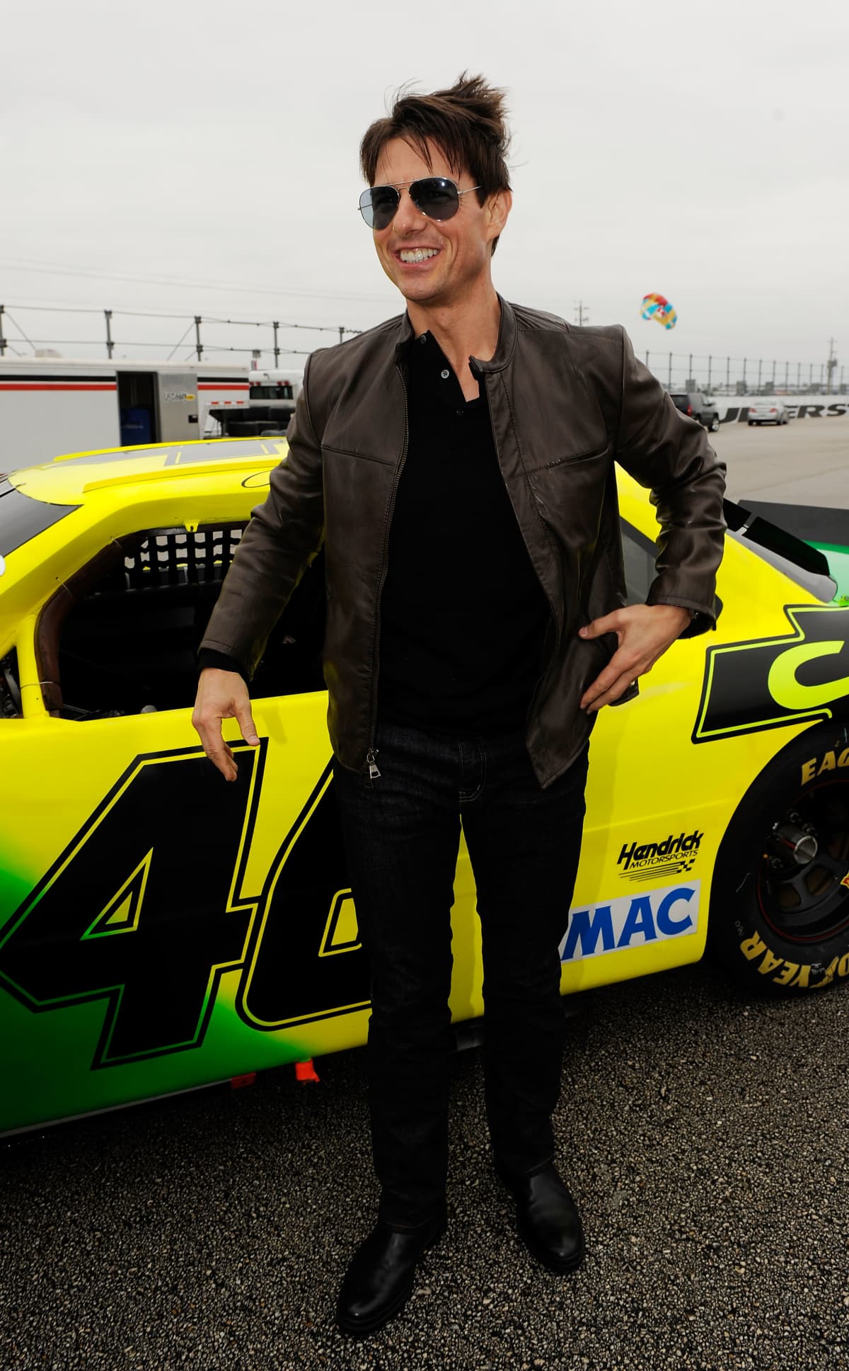 DAYTONA BEACH, FL - FEBRUARY 15:  Actor Tom Cruise poses in front of the car used in the film "Days of Thunder" on track prior to the start of the NASCAR Sprint Cup Series Daytona 500 at Daytona International Speedway on February 15, 2009 in Daytona Beach, Florida.  (Photo by Rusty Jarrett/Getty Images for NASCAR)