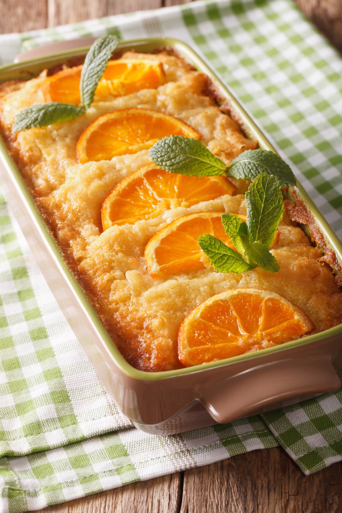 Greek Orange filo pie portokalopita close-up in a baking dish. vertical