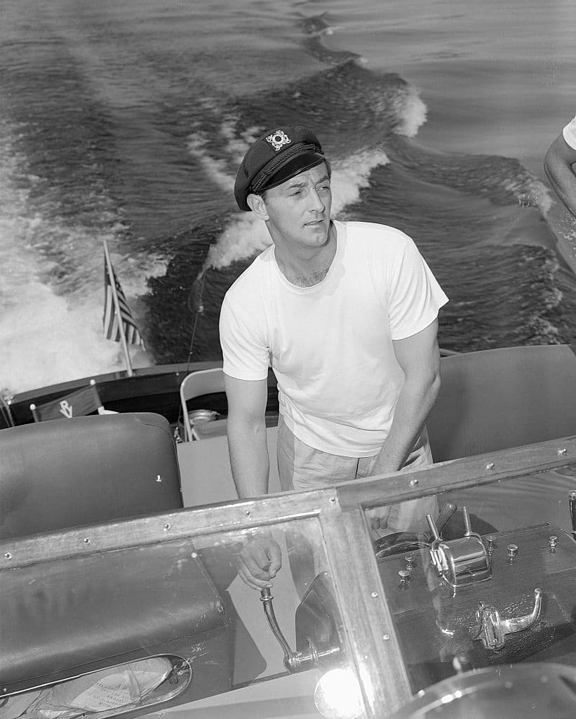 (Original Caption) 1950-Las Vegas, NV- Recovering from recent Hollywood ordeal, actor Robert Mitchum takes a long-planned vacation at Lake Mead behind Hoover (Boulder) Dam where he's shown at the helm of Hotel El Rancho Vegas cruiser enroute to the lake's famed fishing grounds.