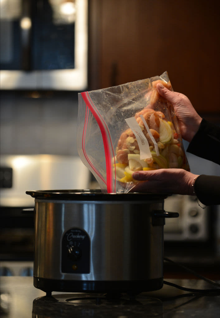 Crock Pot Meals  Susan Shelly pours a bag of ingredients that she premade into a crock pot for an easy-to-prepare meal. Photo by Bill Uhrich  1/8/2018 (Photo By MediaNews Group/Reading Eagle via Getty Images)