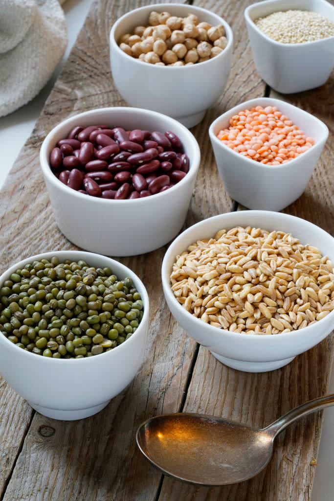 Variety of uncooked superfood cereals, chia, red lentils, pearl spelled, red beans, chickpeas, green azuki on wooden plank, background. (Photo by: Eddy Buttarelli/REDA&CO/Universal Images Group via Getty Images)