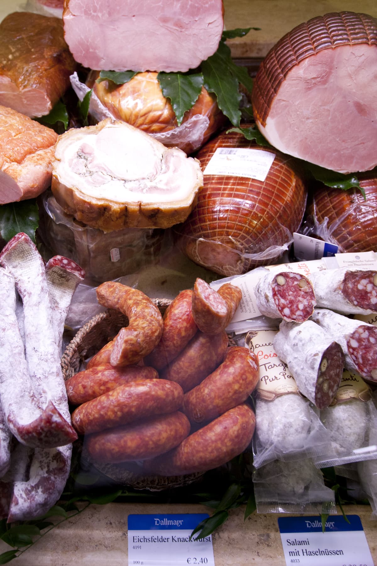 An assortment of cured meats at a market