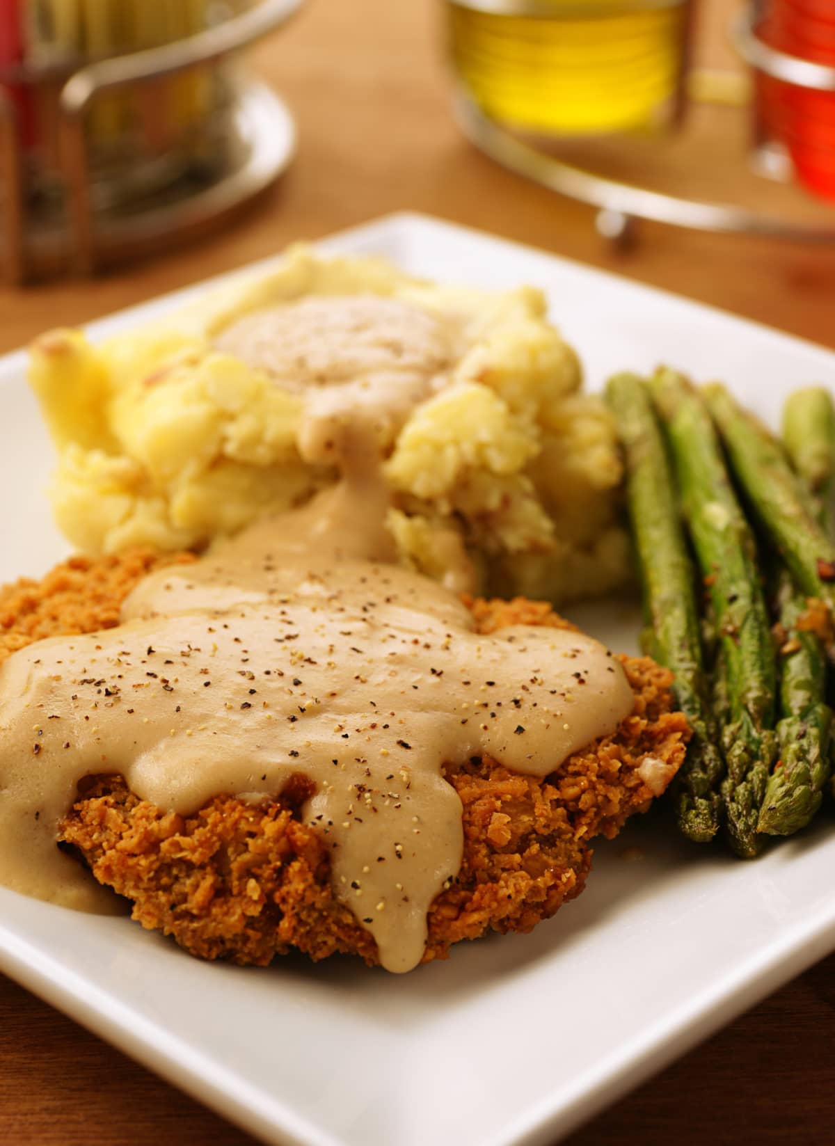 "Chicken fried steak, aka country fried steak, with mashed Yukon gold potatoes, gravy and asparagus."