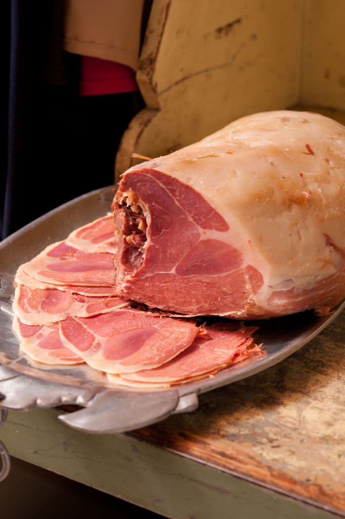 Salt cured ham and slices on tray. (Photo by: Edwin Remsburg/VW Pics via Getty Images)