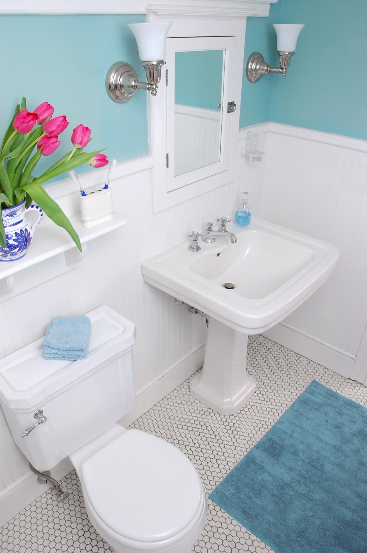 A white bathroom with blue walls.