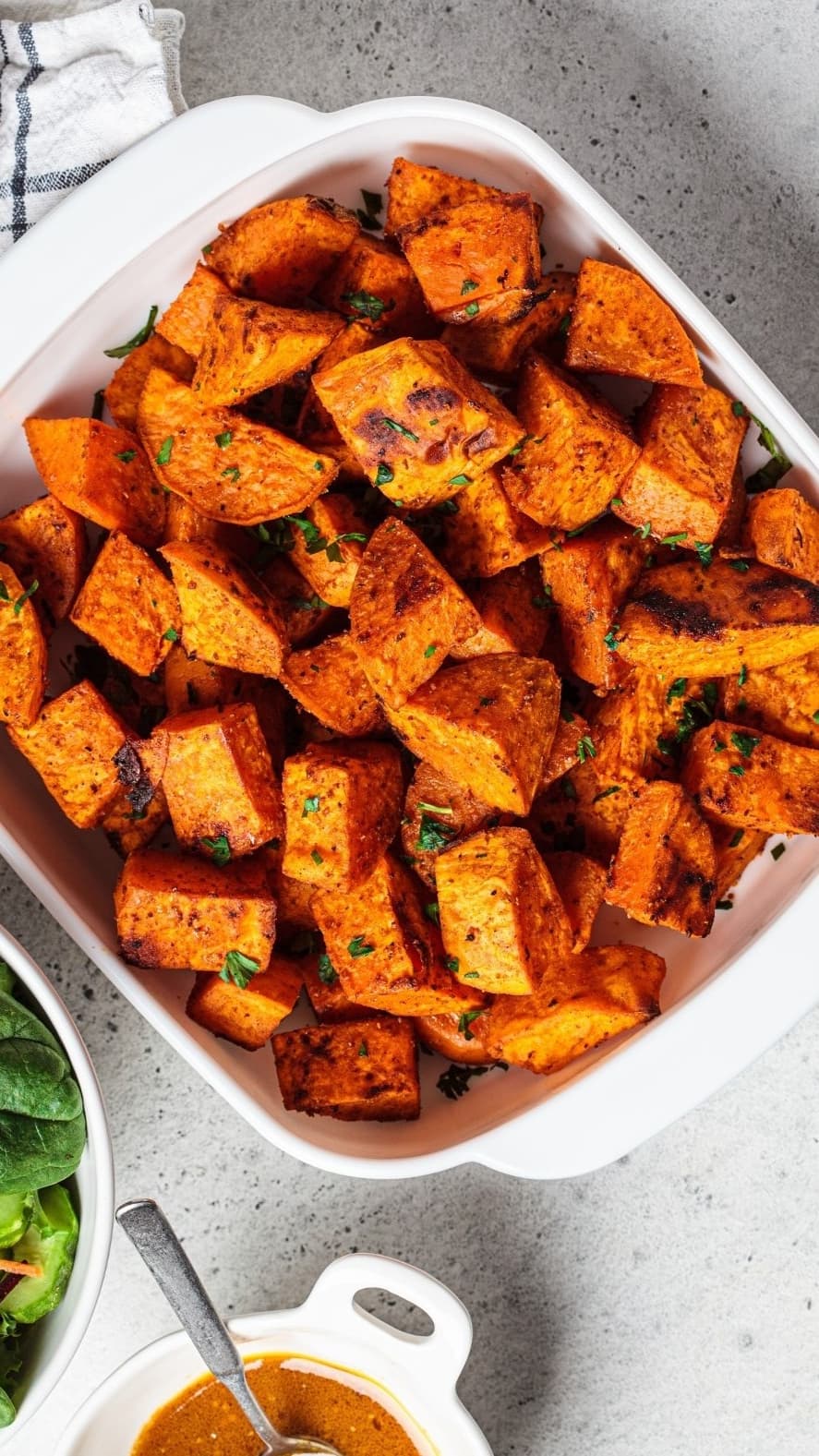 Diced roasted sweet potatoes in a square pan