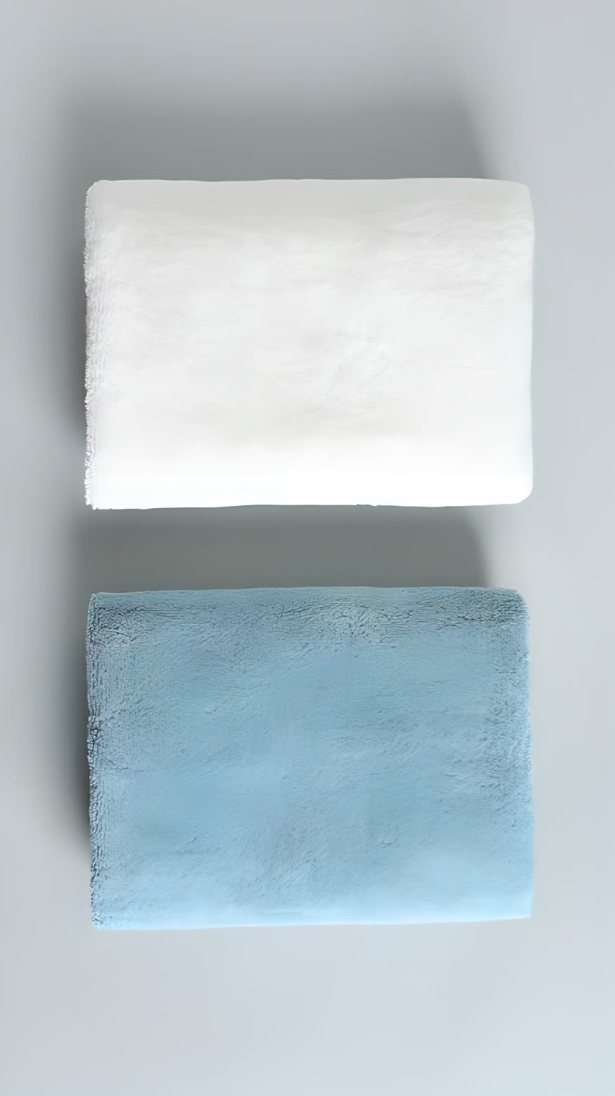 Folded hand towels against a gray background