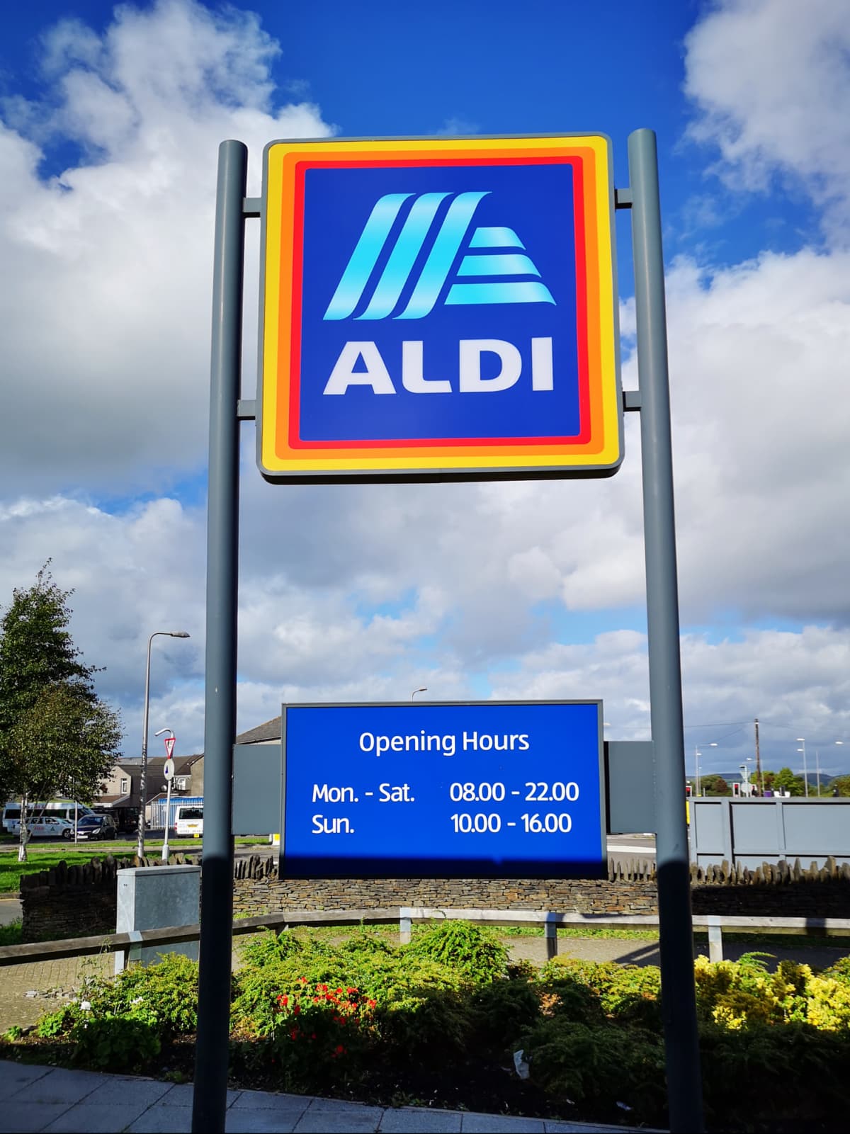 Swansea, UK: September 21, 2018: Commercial sign of ALDI Store against a blue sky. ALDI is the common brand of two German discount supermarket chains with over 10,000 stores in 20 countries, and an estimated combined turnover of more than €50 billion.