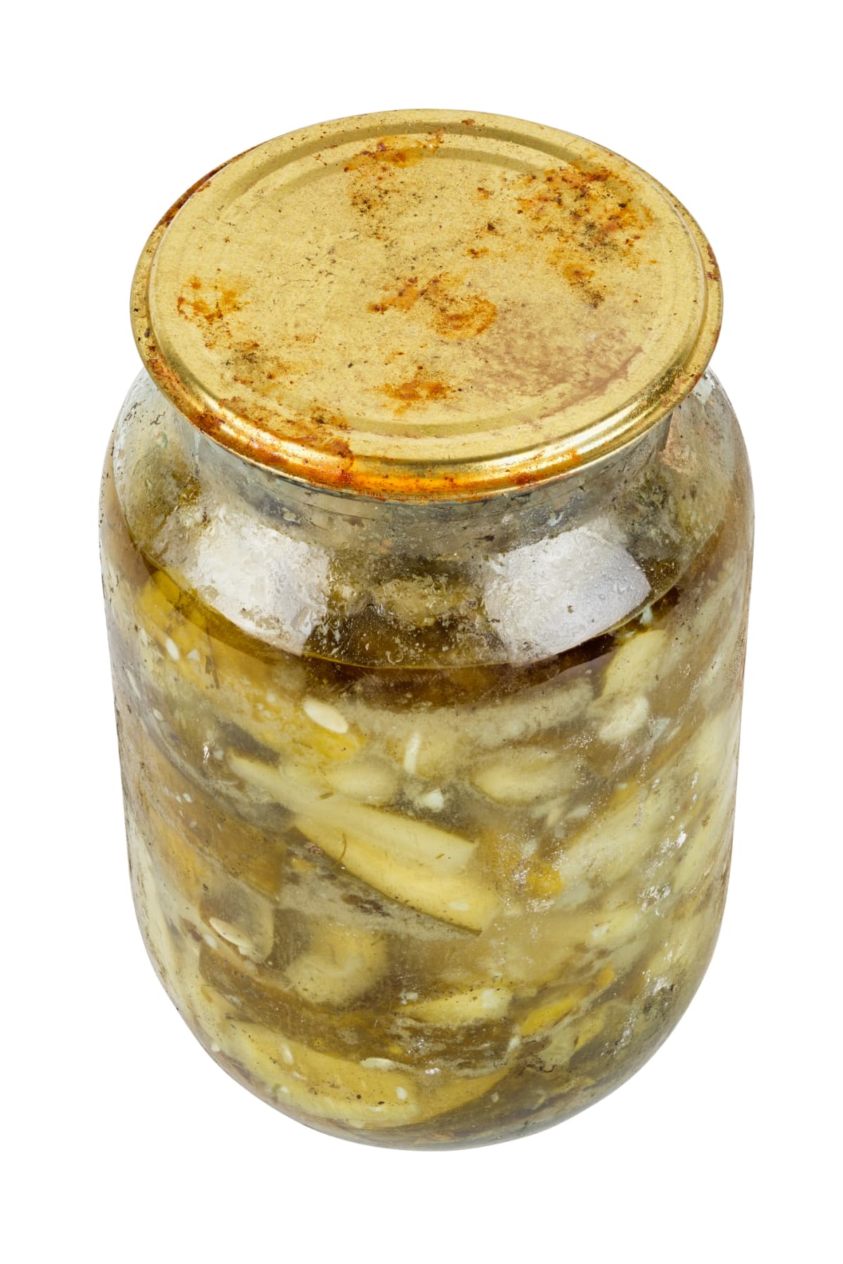old pickles in glass jar with rusted cap in bad condition isolated on white background.