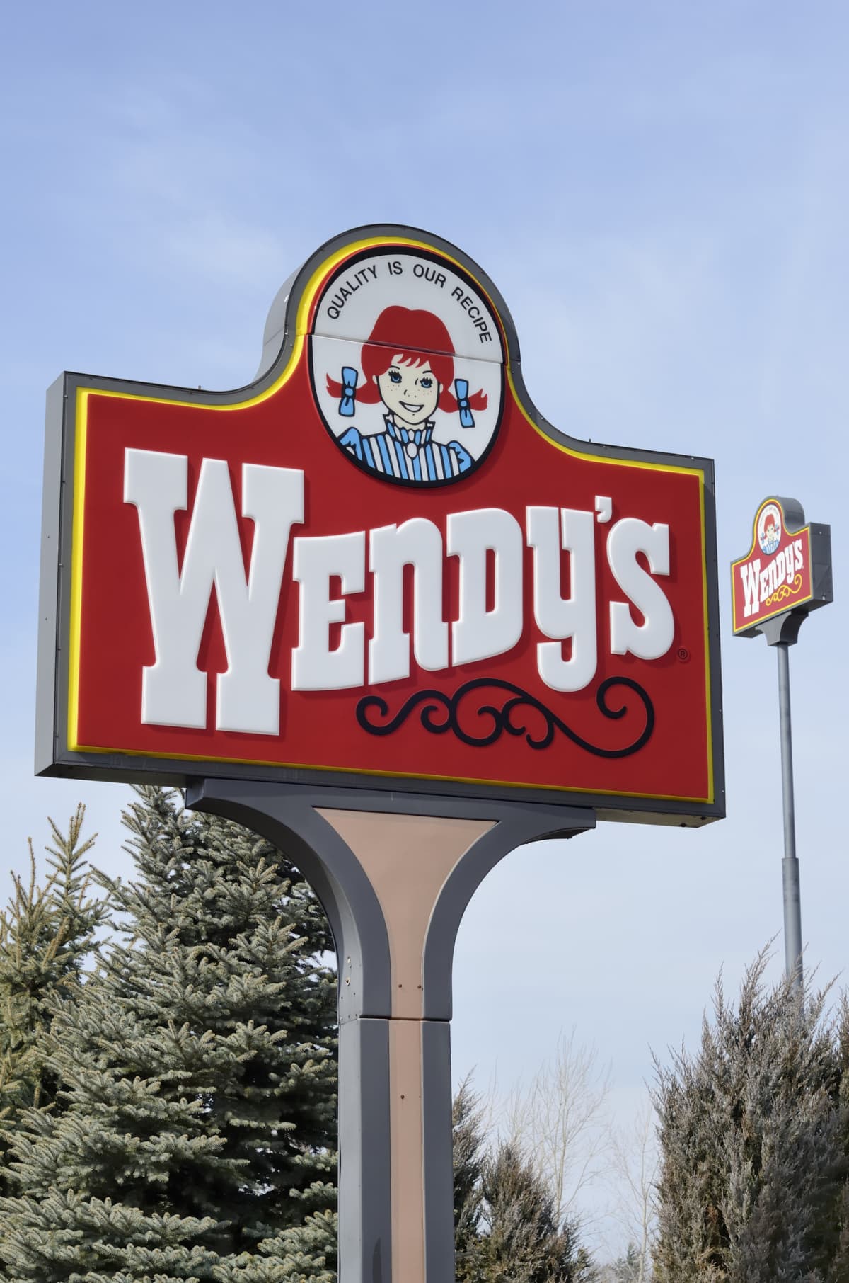 "Clio, Michigan, USA - March 7, 2012: The Wendy's location in Clio, Michigan. Founded in 1969 by Dave Thomas, Wendy's is a chain of fast food restaurants with over 6,600 locations in the US and abroad."