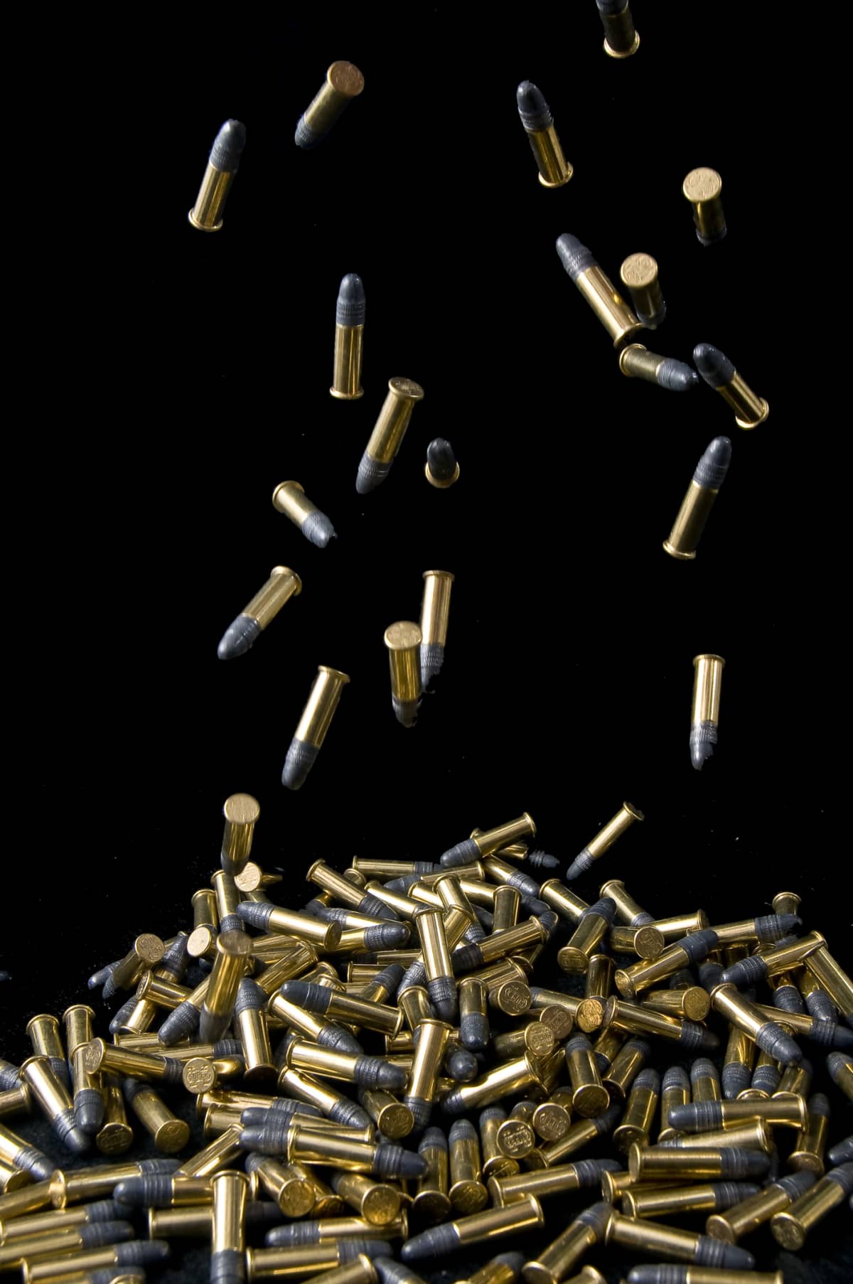 Bullets falling into  pile.
