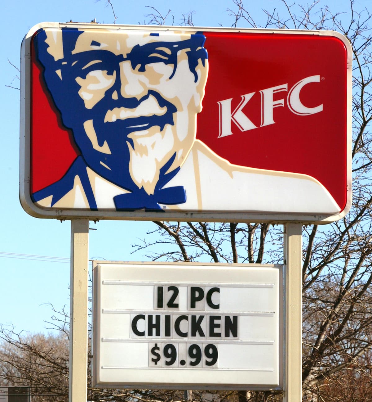 Banner sign Colonel Sanders advertising KFC  Kentucky Fried Chicken Drive Thru outlet, Martlesham, Suffolk, England, UK. (Photo by: Geography Photos/UCG/Universal Images Group via Getty Images)