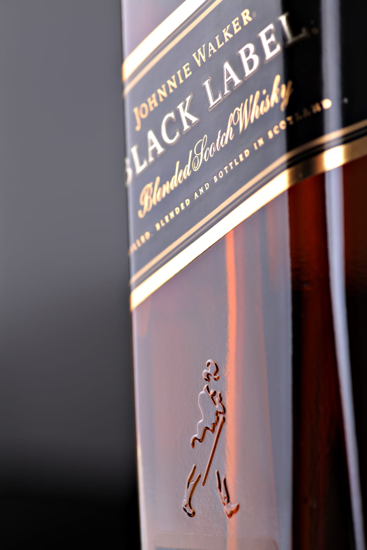 "Bucharest, Romania - July 15, 2011: Close-up shot of a bottle of Johnnie Walker whiskey. Johnnie Walker is a brand of Scotch Whisky owned by Diageo and originated in Kilmarnock, Ayrshire, Scotland."