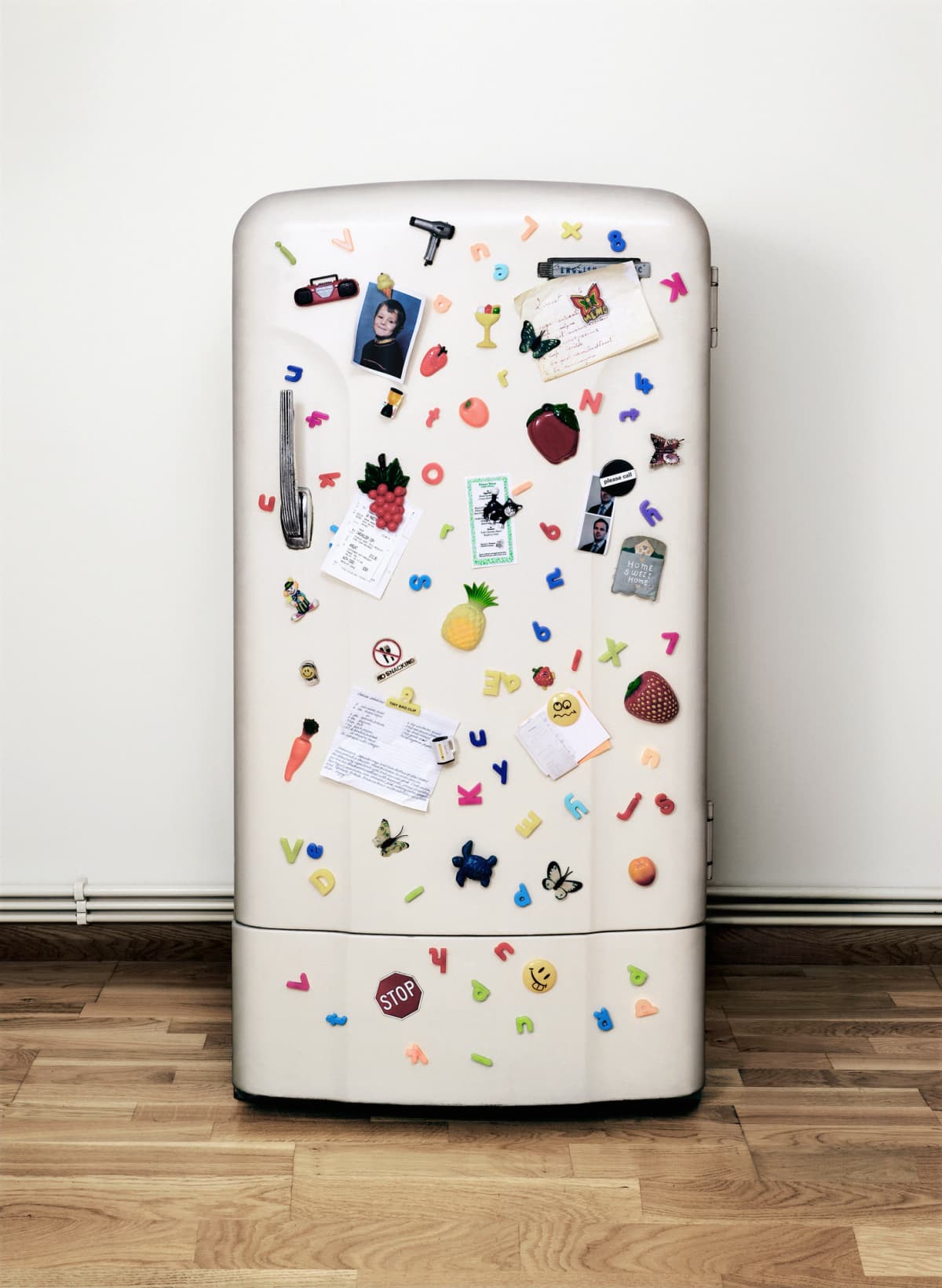 A fridge covered in magnets, notes, and photographs