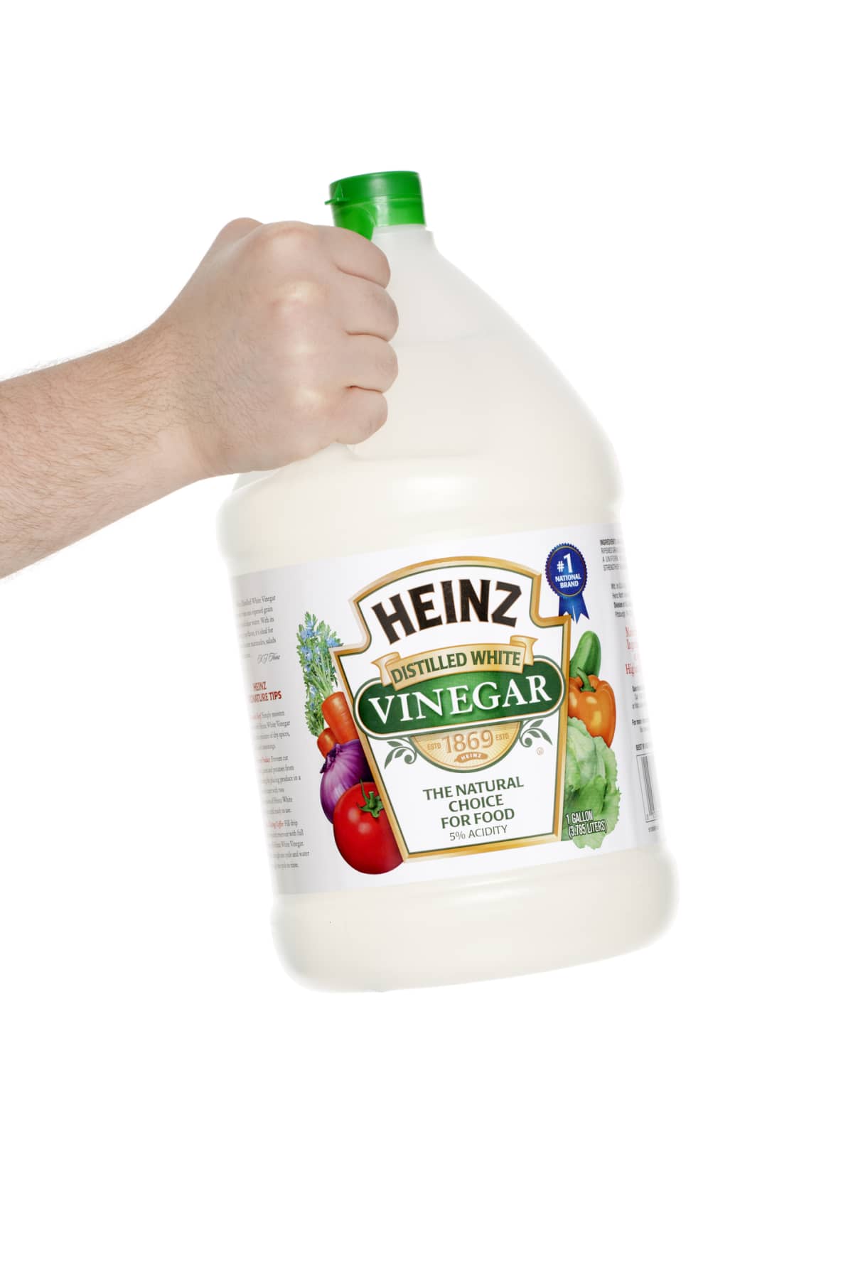 A person holding a jar of distilled white vinegar