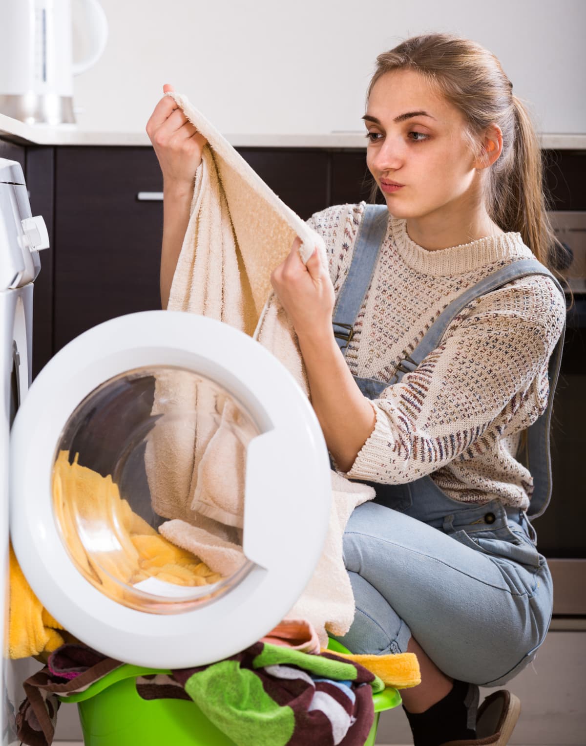 person looking unhappily at stained laundry