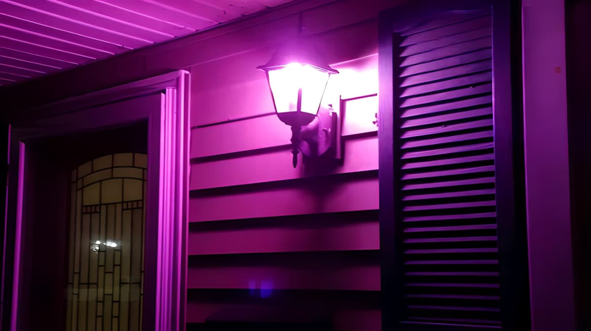 A house with a pink porch light