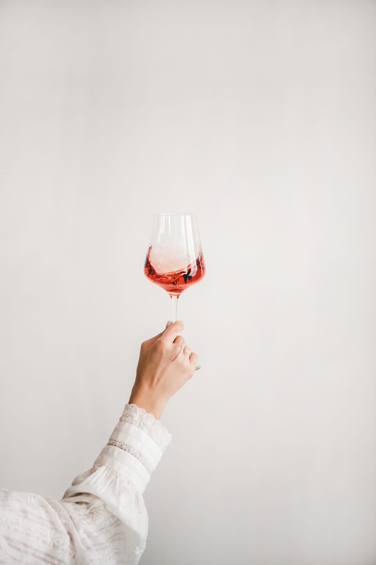 Woman's hand holding wine glass