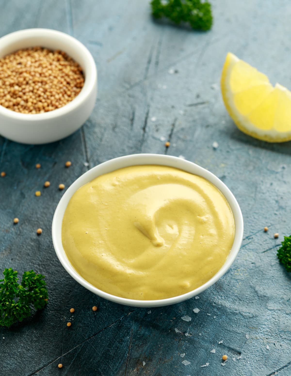 Mustard in a bowl with mustard seeds