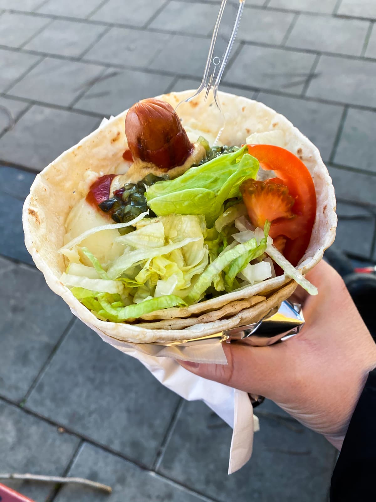 Flatbread wrap with instant mash potatoes, grilled hot dog and salad. Swedish fast food.