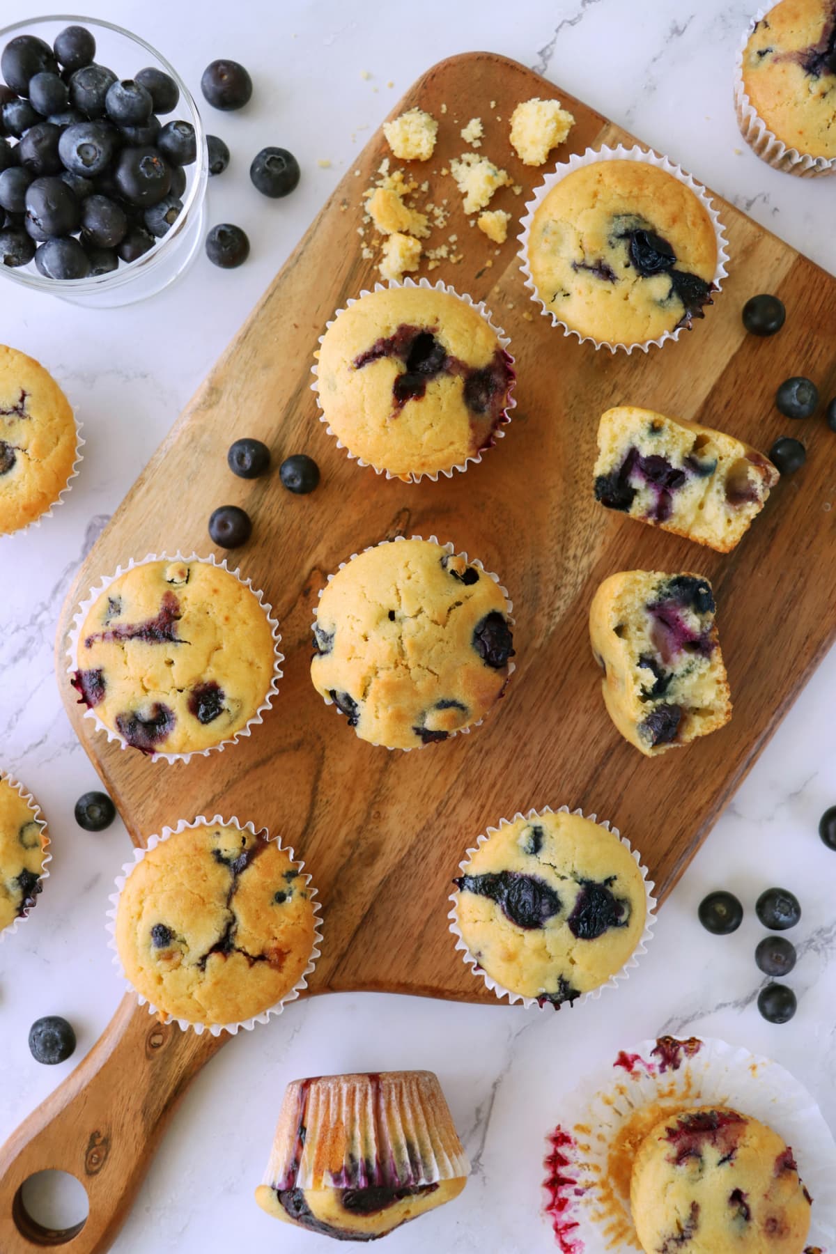 Blueberry muffins on a wooden board. 