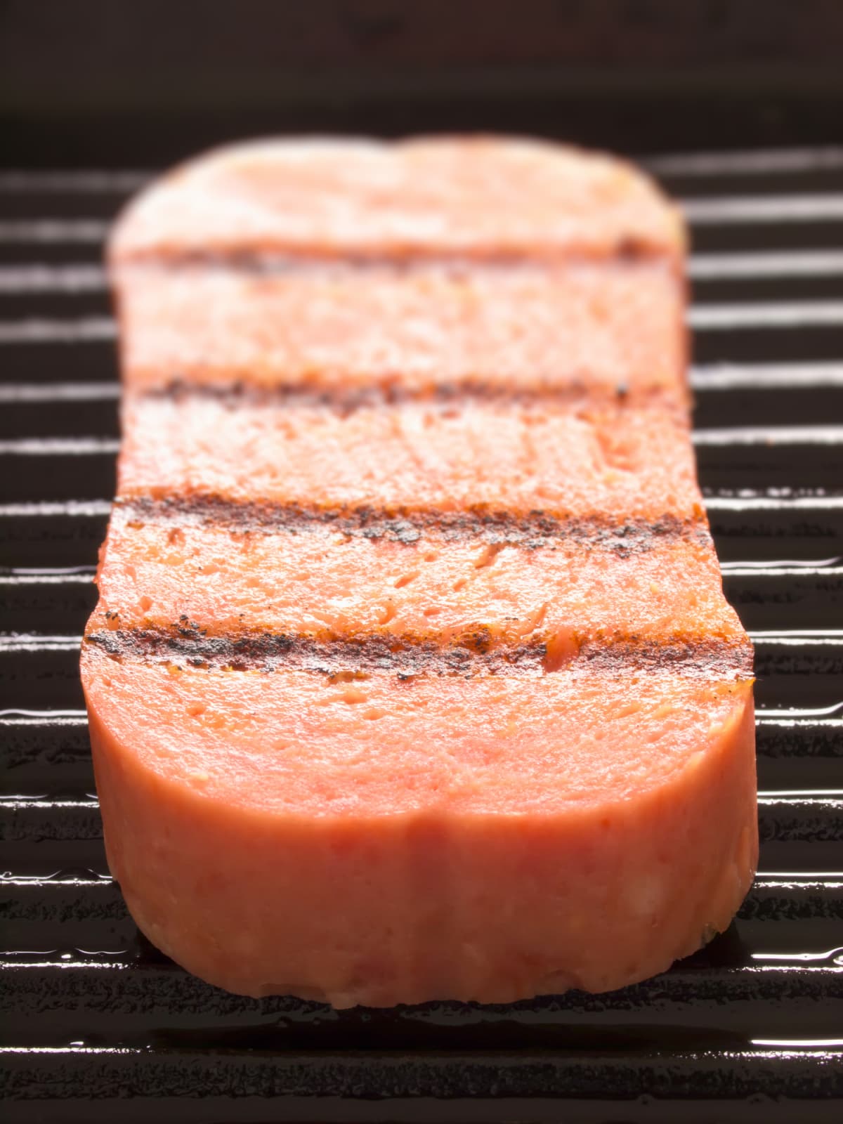 Slice of spam on a grill