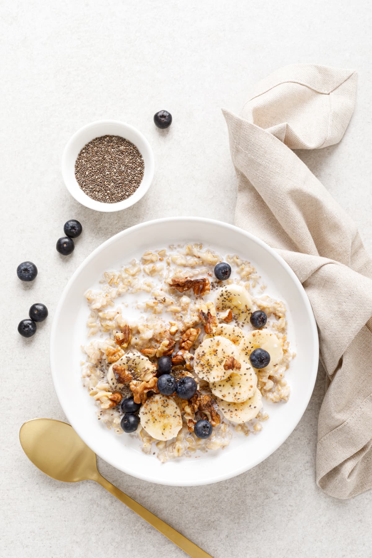 Healthy breakfast oatmeal porridge wit blueberries, cranberries, wallnuts and chia seeds. Dieting breakfast foods