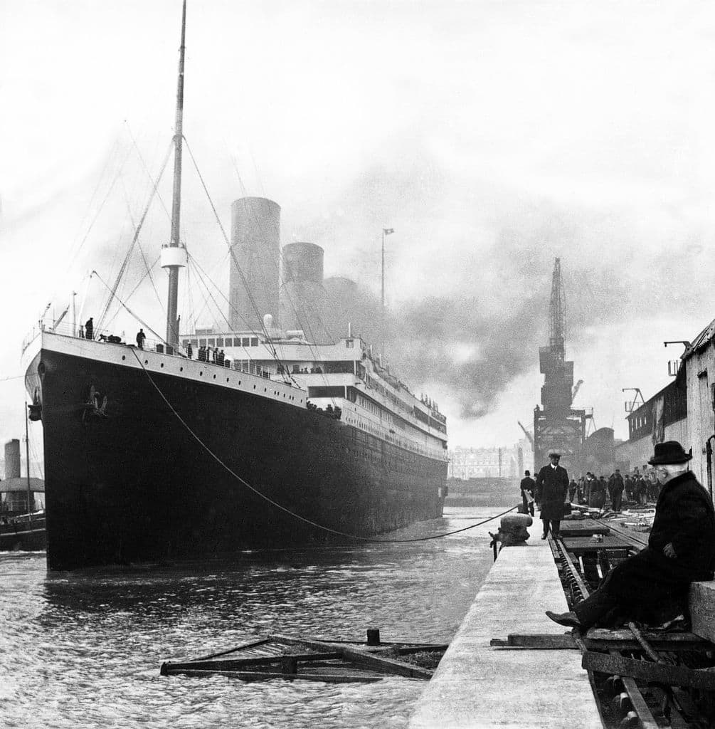 Computer generated 3D illustration with the historic passenger ship Titanic on the high seas in black and white