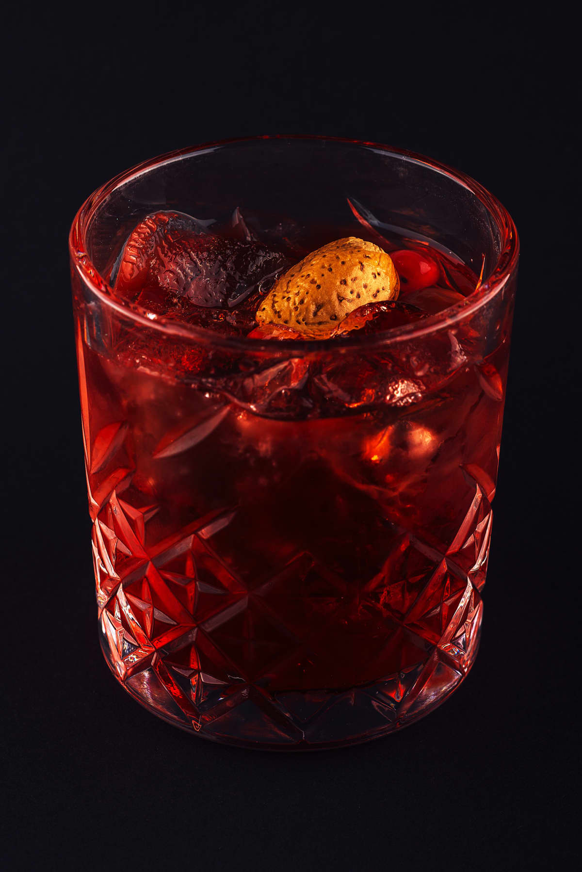 red drink cocktail in glass jar with cherry