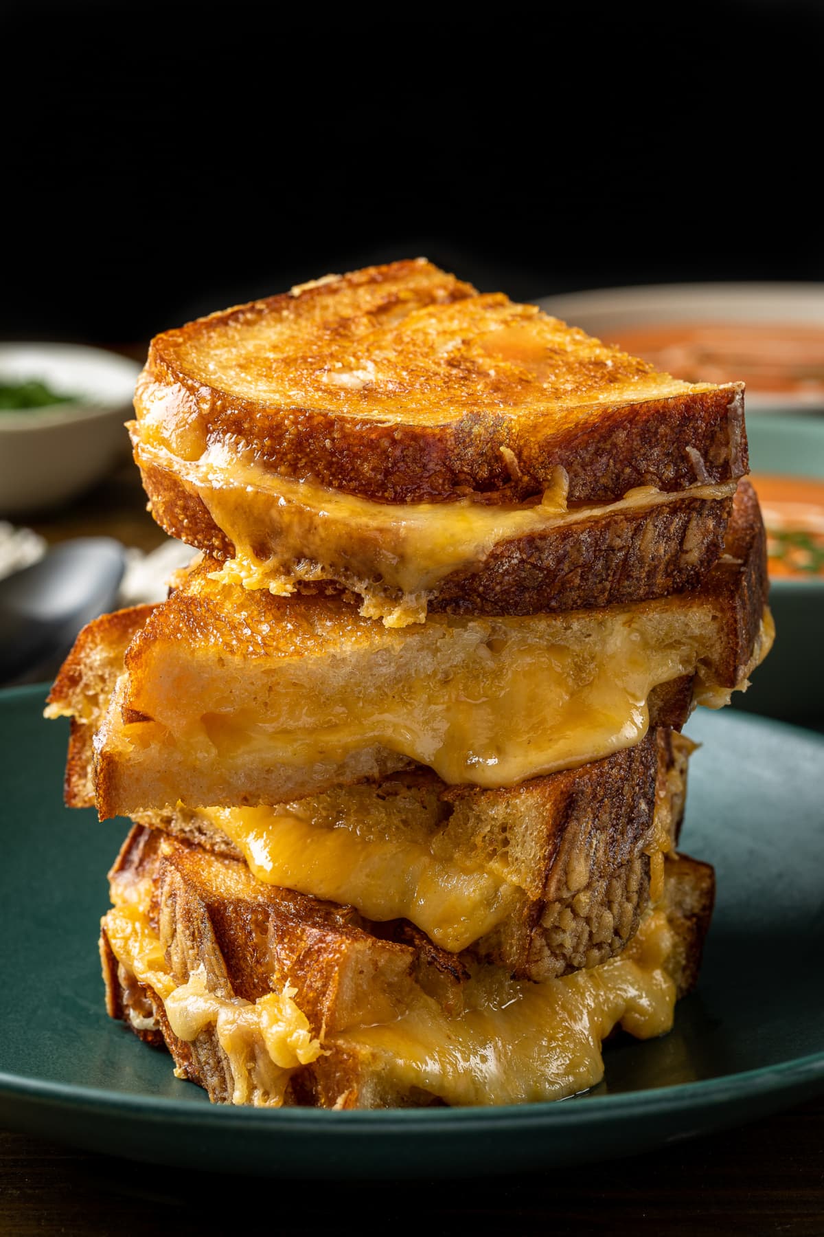 Stack of sliced grilled cheeses on plate