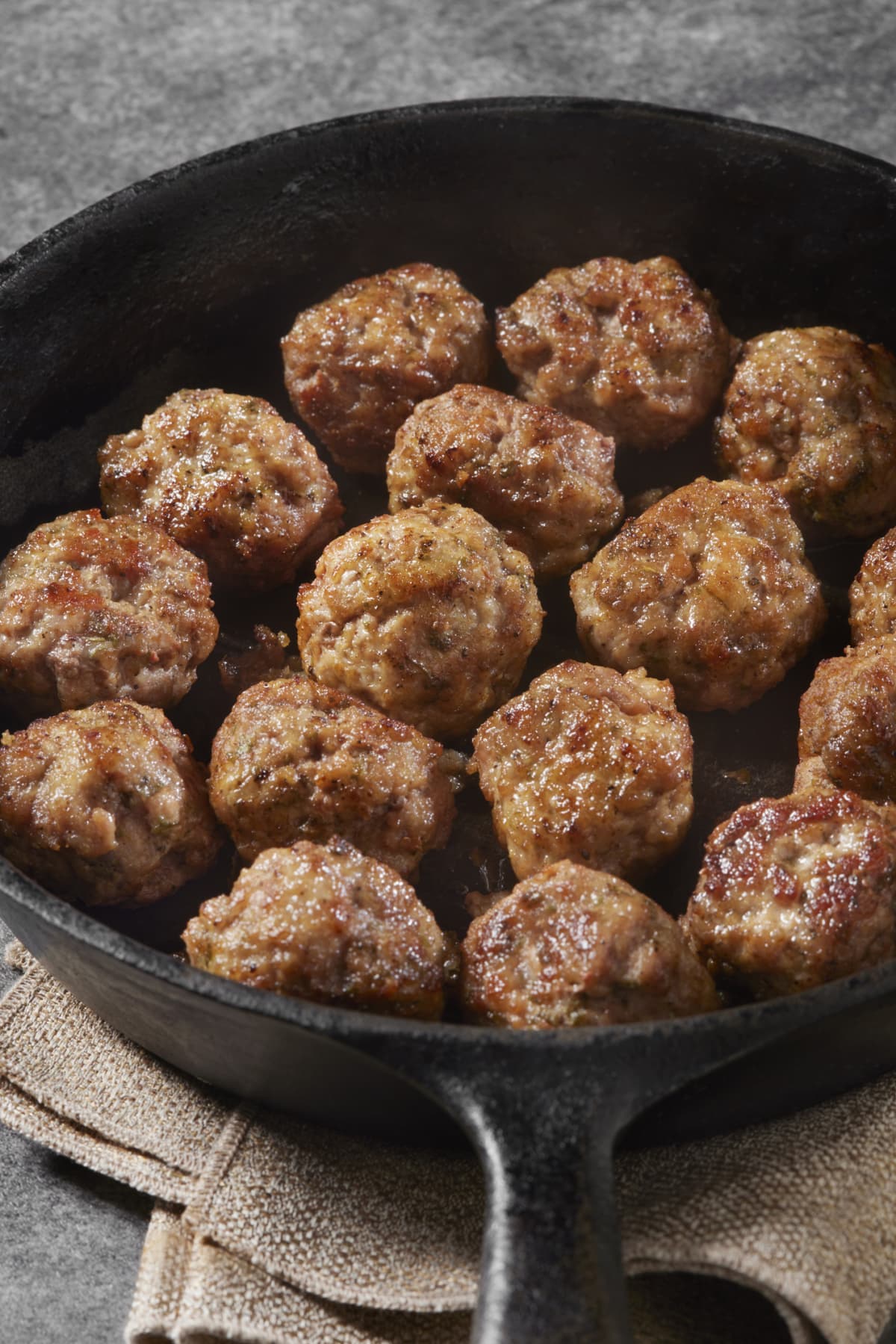 A bowl of cooked meatballs 