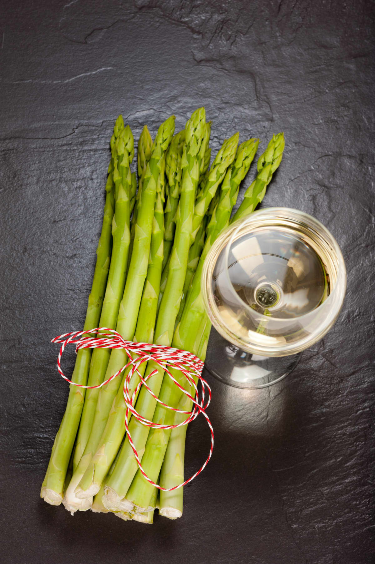Bunch of asparagus ad glass of wine