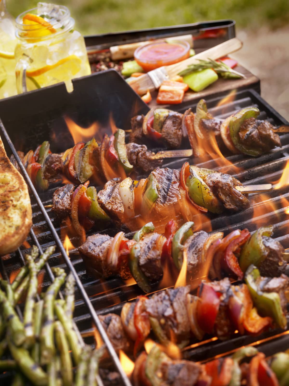 Meat and veggie kabobs on a grill over a fire