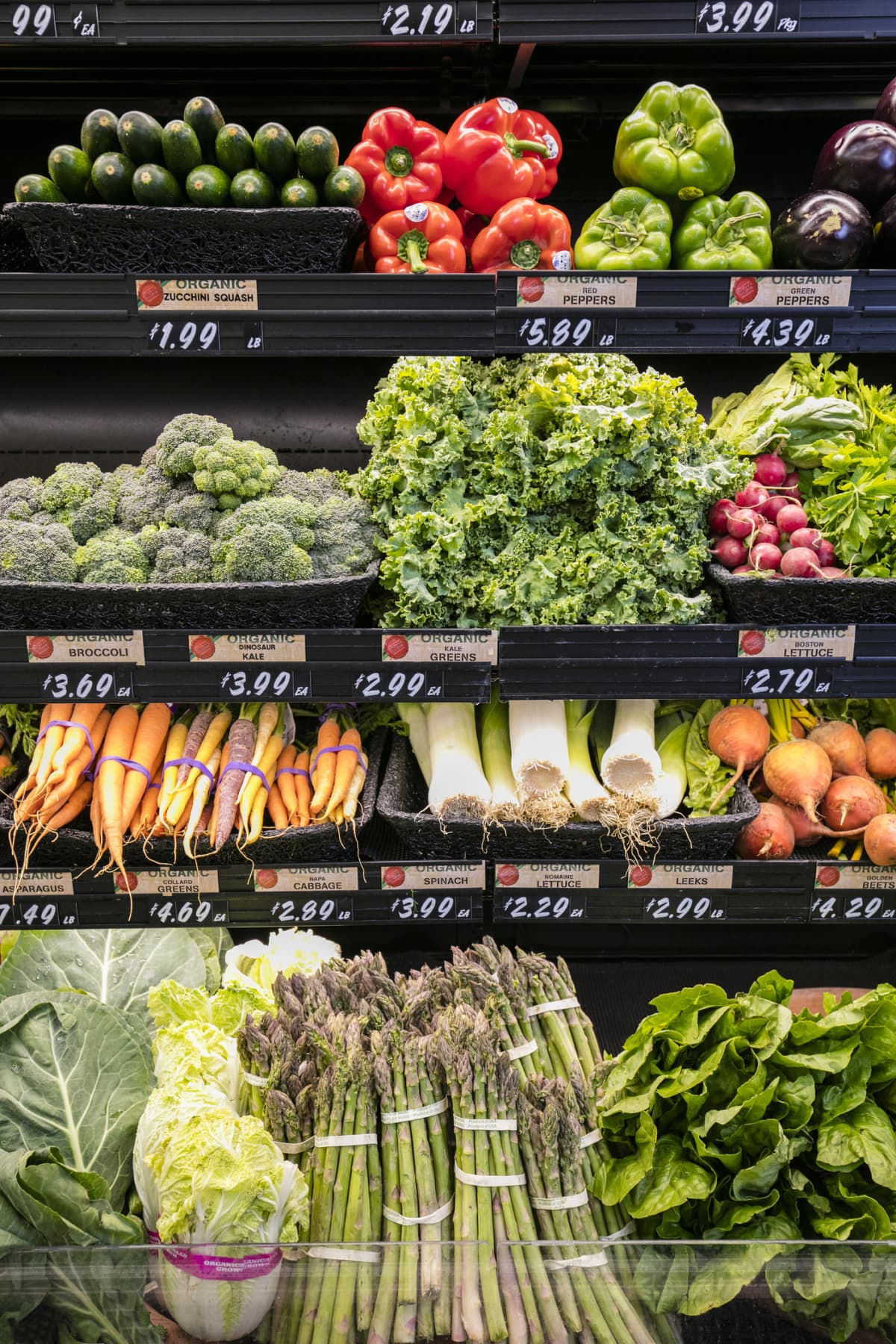 Produce section in grocery store with various vegetables