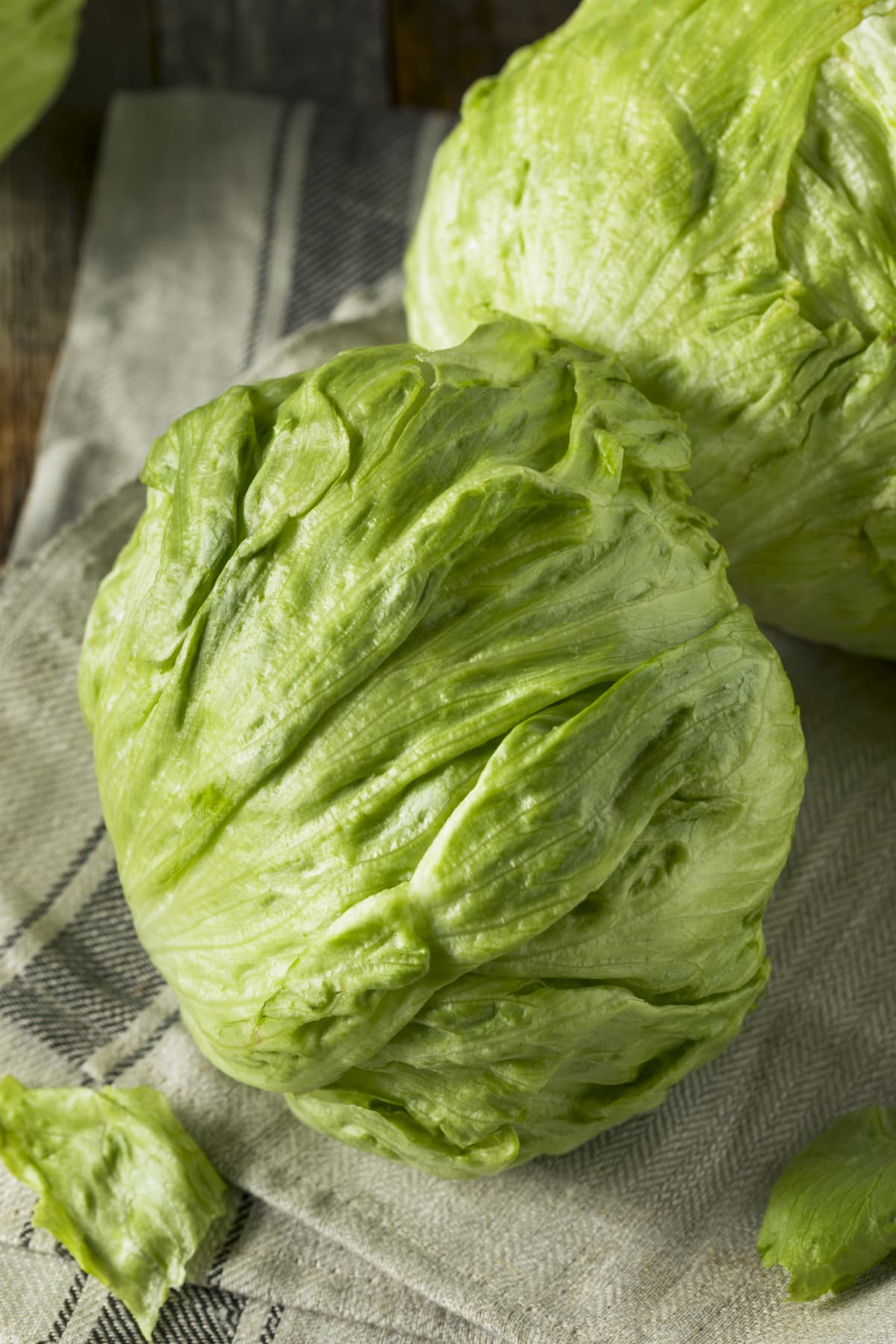 Iceberg lettuce: fresh, organic, freshly picked in a box, top view.