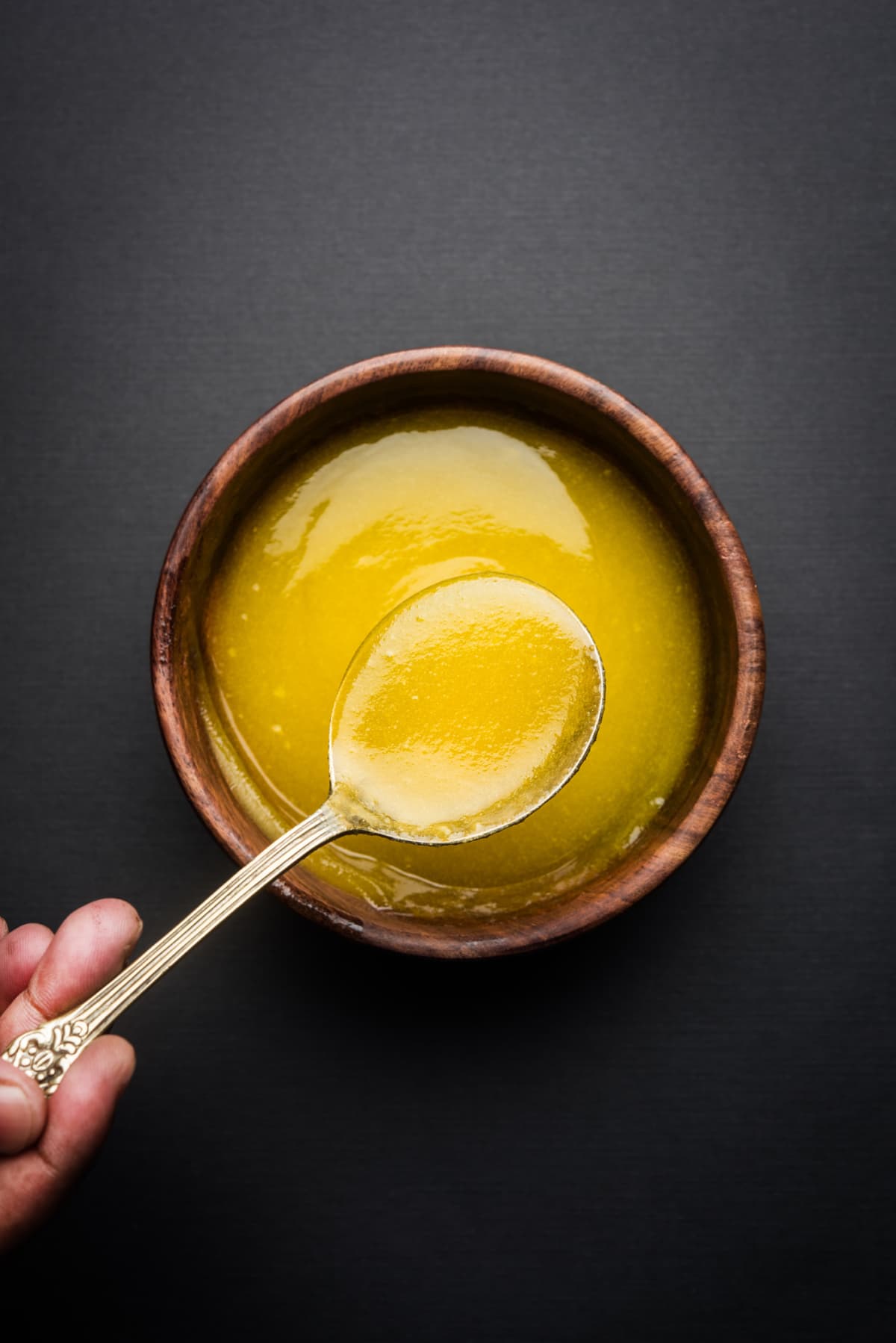Wooden bowl of clarified butter with spoon