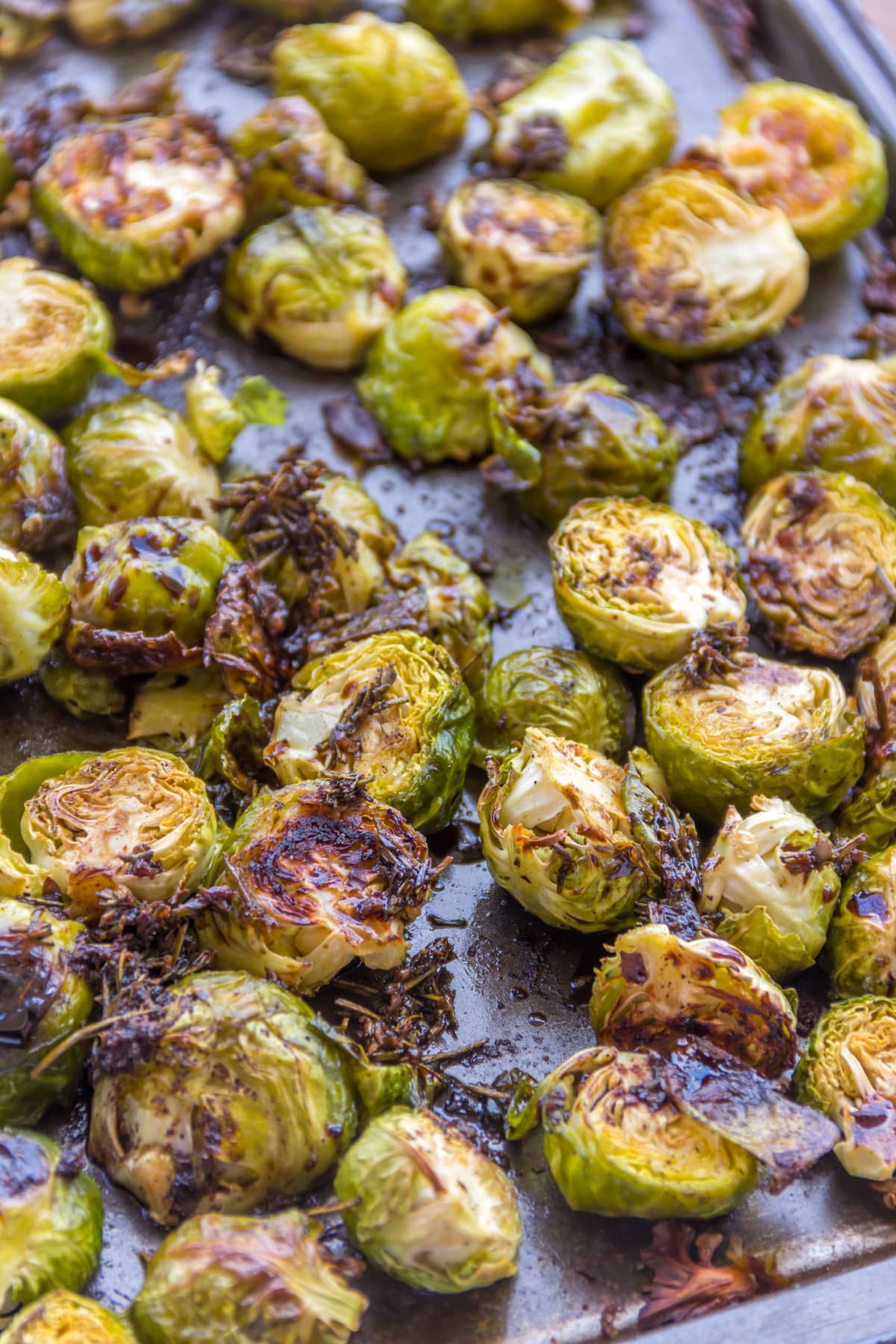 Roasted Brussels Sprouts Mixed with Balsamic Sauce Served in a Baking Tray.