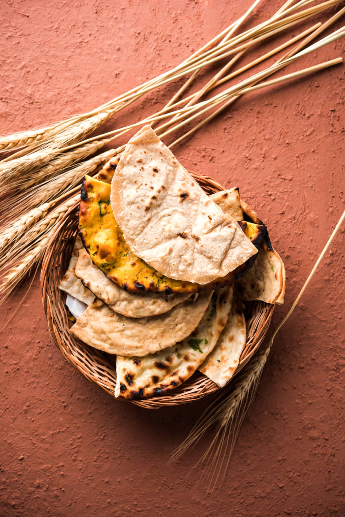Assorted Indian Bread Basket includes chapati, tandoori roti or naan, paratha, kulcha, fulka, missi roti