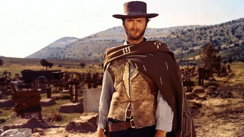 (Original Caption) Movie still of Clint Eastwood starring in the 1976 Western The Outlaw Josey Wales, directed by Clint Eastwood himself. Photo shows him from the waist-up holding two pistols, one pointing to his left and one pointing up, arms crossed.