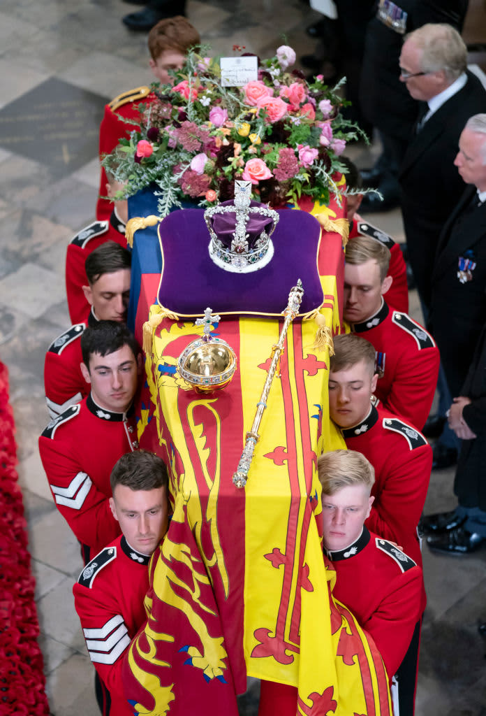 WINDSOR, UNITED KINGDOM - SEPTEMBER 19: (EMBARGOED FOR PUBLICATION IN UK NEWSPAPERS UNTIL 24 HOURS AFTER CREATE DATE AND TIME) Pallbearers from Queen's Company, 1st Battalion Grenadier Guards carry Queen Elizabeth II's coffin, draped in the Royal Standard, into St George's Chapel, Windsor Castle for her Committal Service on September 19, 2022 in Windsor, England. The committal service at St George's Chapel, Windsor Castle, took place following the state funeral at Westminster Abbey. A private burial in The King George VI Memorial Chapel followed. Queen Elizabeth II died at Balmoral Castle in Scotland on September 8, 2022, and is succeeded by her eldest son, King Charles III. (Photo by Max Mumby/Indigo/Getty Images)